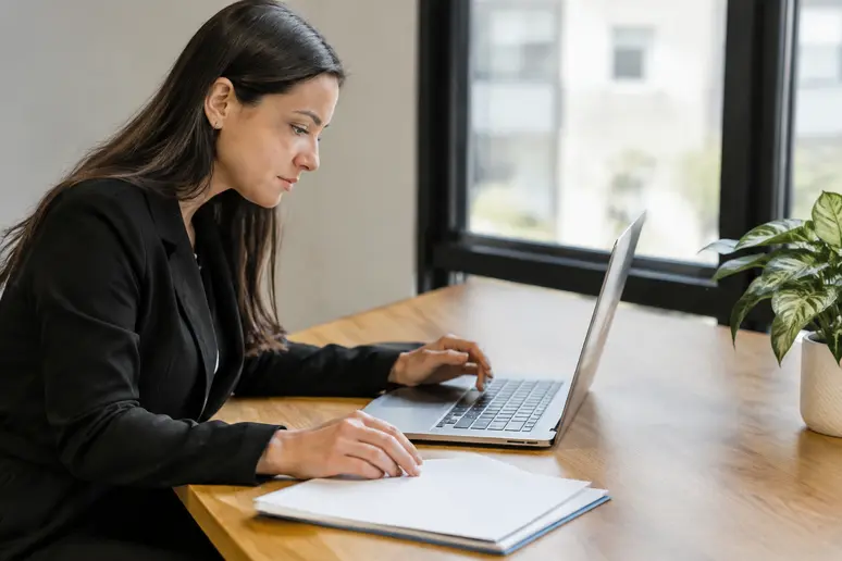 Employé renommant un fichier PDF professionnel avant son envoi par courrier électronique